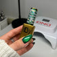 DND DIVA 9D Cat Eye Gel Polish in Jungle Cat shade with glassball effect, showcasing vibrant green and gold hues on nails.