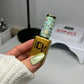 DND Diva 9D Cat Eye Gel Polish in Leafy Prowl, featuring a shimmering green and gold glassball effect on a smooth nail surface.