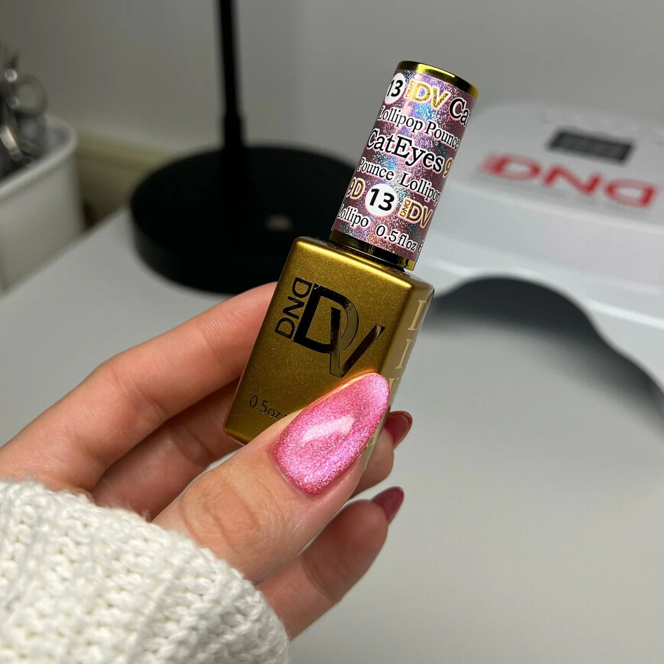 DND Diva 9D Cat Eye Gel Polish in shade Lollipop Pounce with glassball effect, showcasing a vibrant, shimmering nail color.