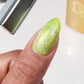 DND Diva 9D Cat Eye Gel Polish in Lemon Whiskers, featuring a glassball finish and vibrant yellow color with cat eye shimmer.