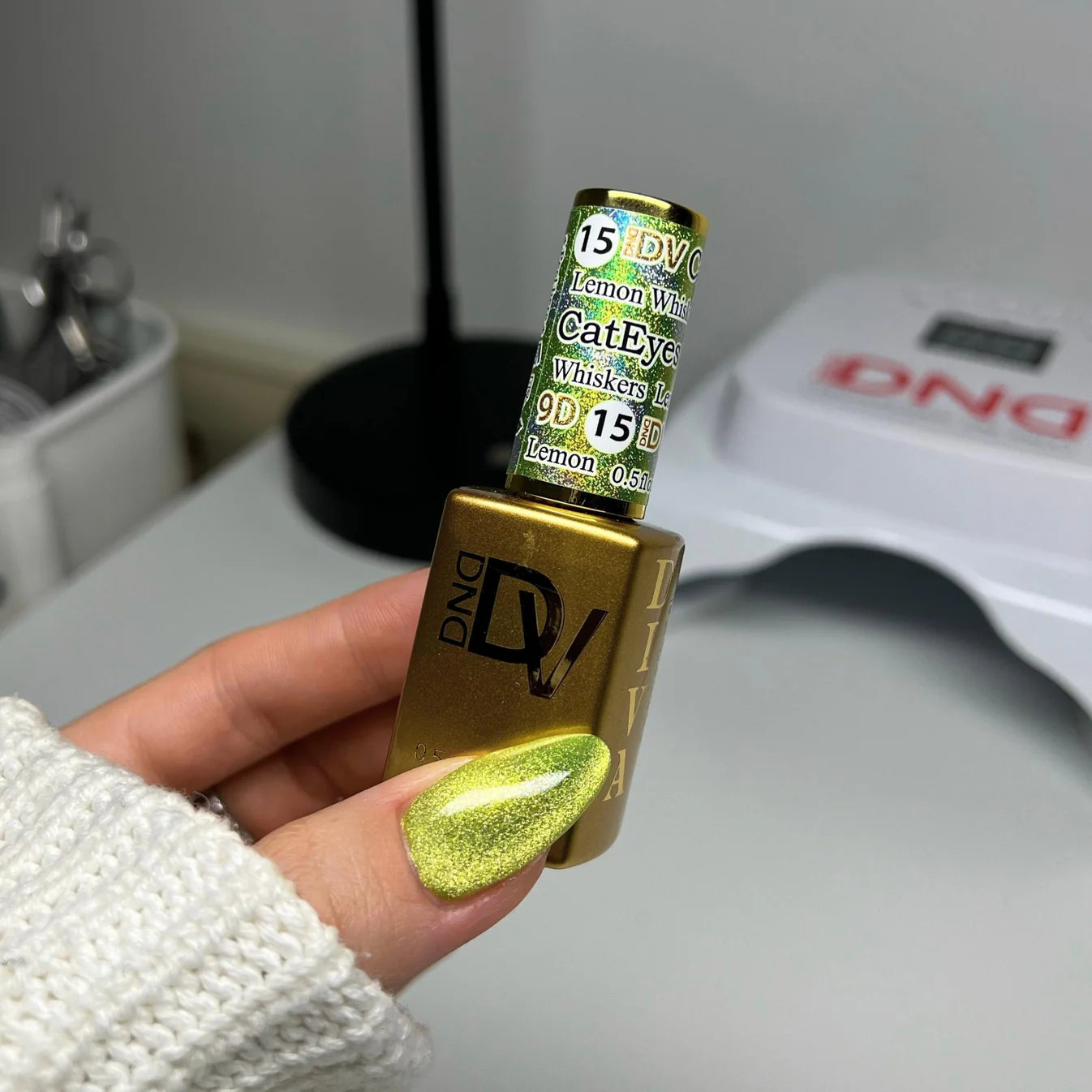 DND Diva 9D Cat Eye Gel Polish in Lemon Whiskers with glassball effect, showcasing vibrant yellow color and shiny finish.