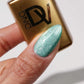 DND Diva 9D Cat Eye Gel Polish in Leopard Mint shade with glassball effect, showcasing vibrant green and gold feline-inspired design.