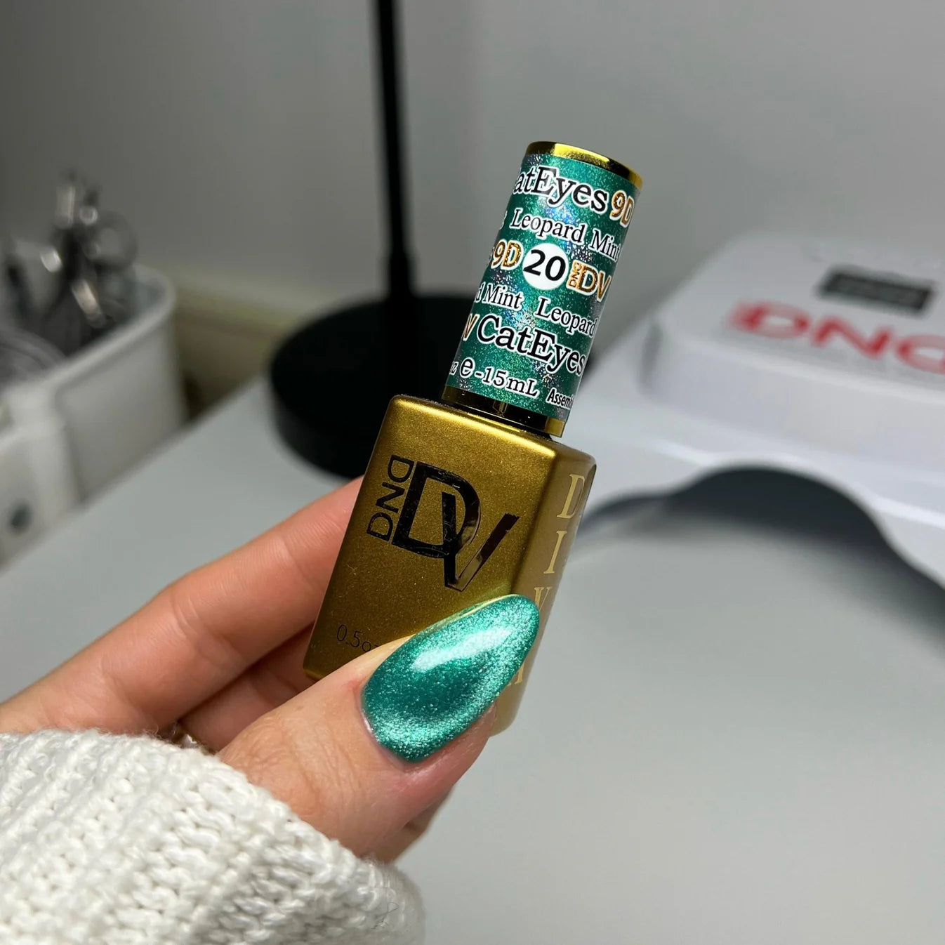 DND Diva 9D Cat Eye Gel Polish in Leopard Mint with glassball finish, showcasing vibrant green and leopard pattern design.