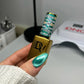 DND Diva 9D Cat Eye Gel Polish in Leopard Mint with glassball finish, showcasing vibrant green and leopard pattern design.
