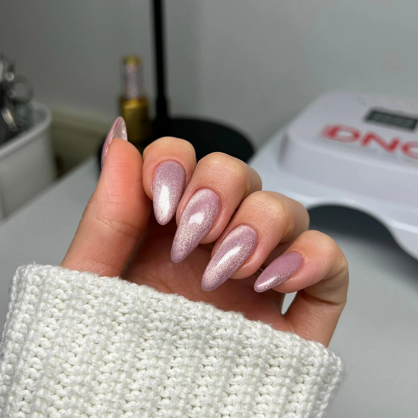 DND Diva 9D Cat Eye Gel Polish in shade Just Kitten, showcasing the vibrant purple and pink glassball effect on a nail art design.