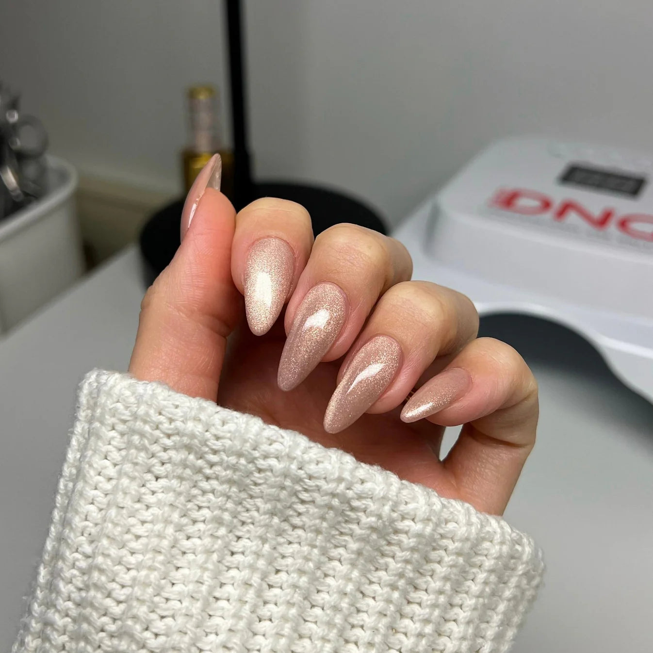 DND Diva 9D Cat Eye Gel Polish in Afterglow, showing a shimmering blue and purple glassball finish on the nail polish bottle.