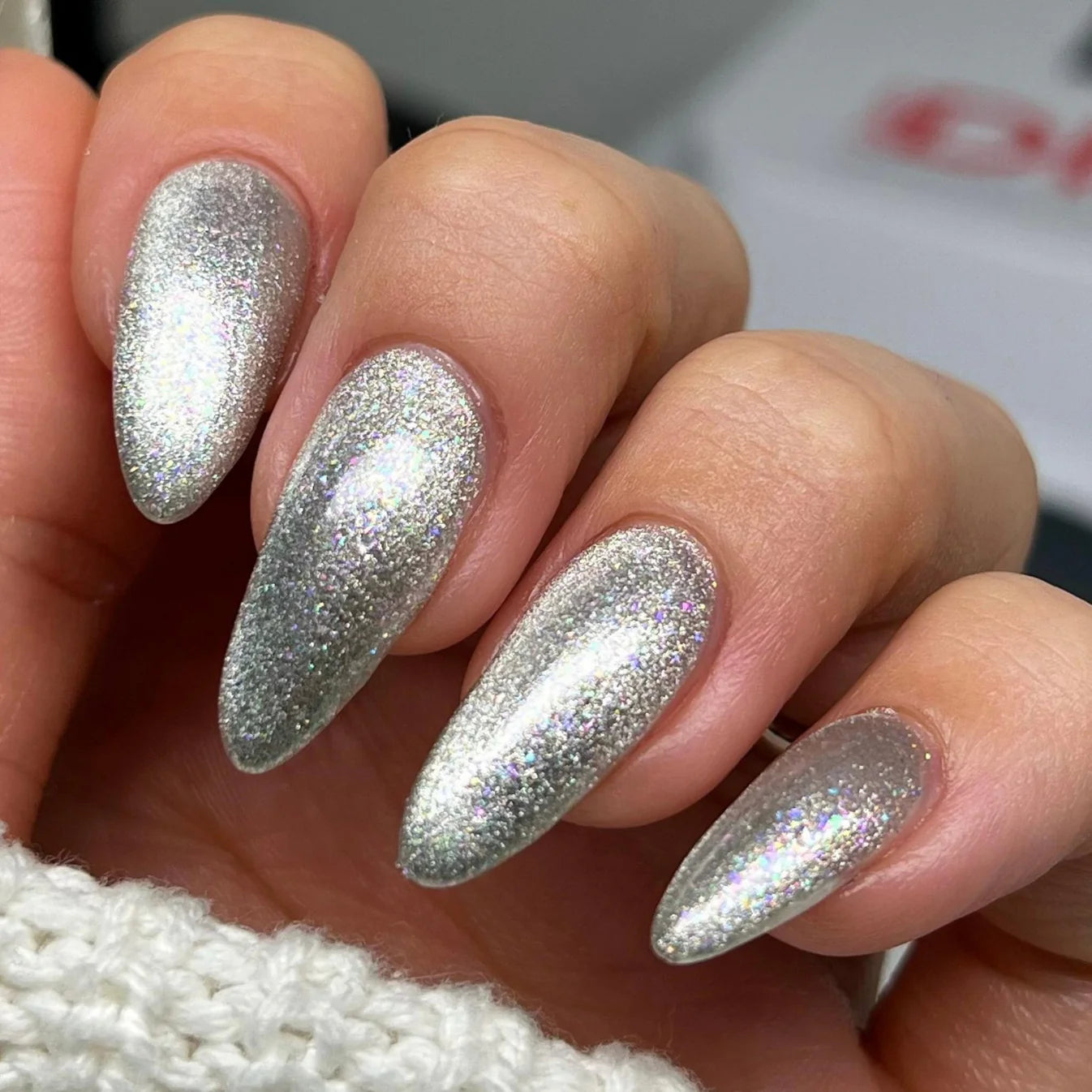 DND Diva 9D Cat Eye Gel Polish in shade Pet Diary, showcasing shimmering glassball effect and vibrant color on a nail.