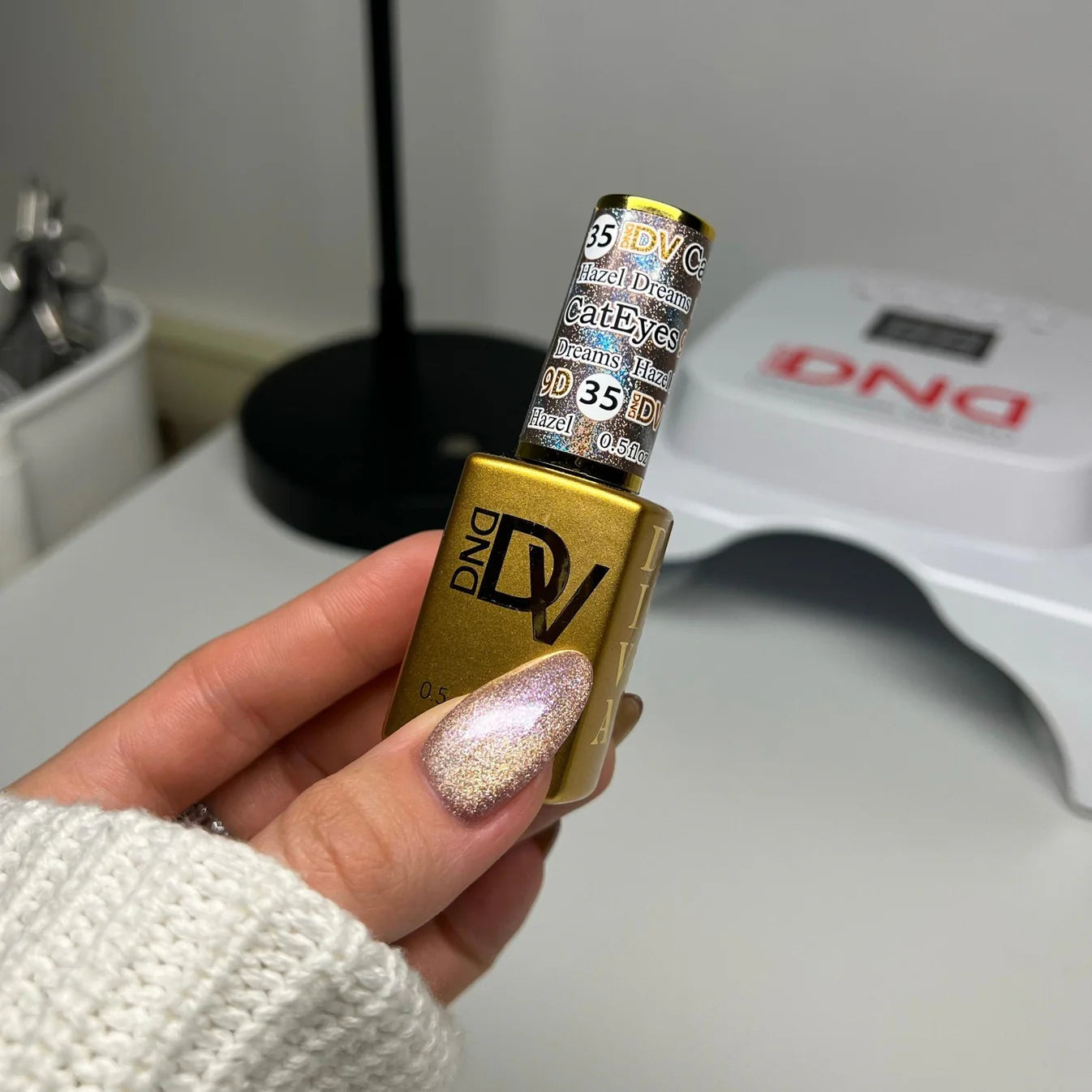 DND Diva 9D Cat Eye Gel Polish in Hazel Dreams, featuring a glassball finish and 9D holographic effect with a rich hazel color.