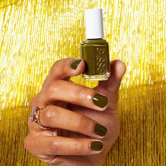 Essie Meet Me At Midnight #1797 nail lacquer bottle with dark midnight blue polish and white cap, displayed against a neutral background.