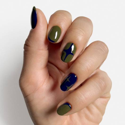 Essie Meet Me At Midnight #1797 nail lacquer in a dark, shimmering blue shade, displayed with a step-out nail art look.