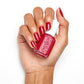 Essie nail lacquer in the shade Not Red-y for Bed, showcasing the vibrant red color on a hand with neatly painted nails.