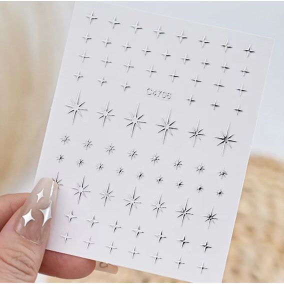 Silver 3D mixed shape nail art decoration stickers by UNS, featuring five pieces of intricate nail embellishments on a white background.