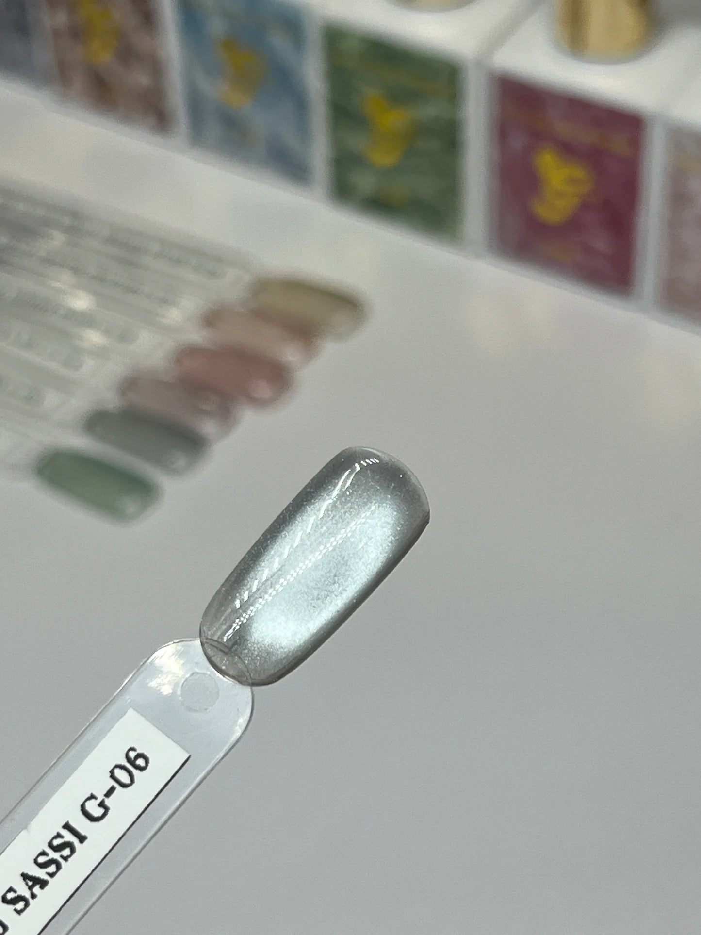 Sofi Art Gellicure Pro Cat Eye Gel Bead Series Sassi G-06 in a close-up of the gel nail polish with shimmering purple and pink hues.