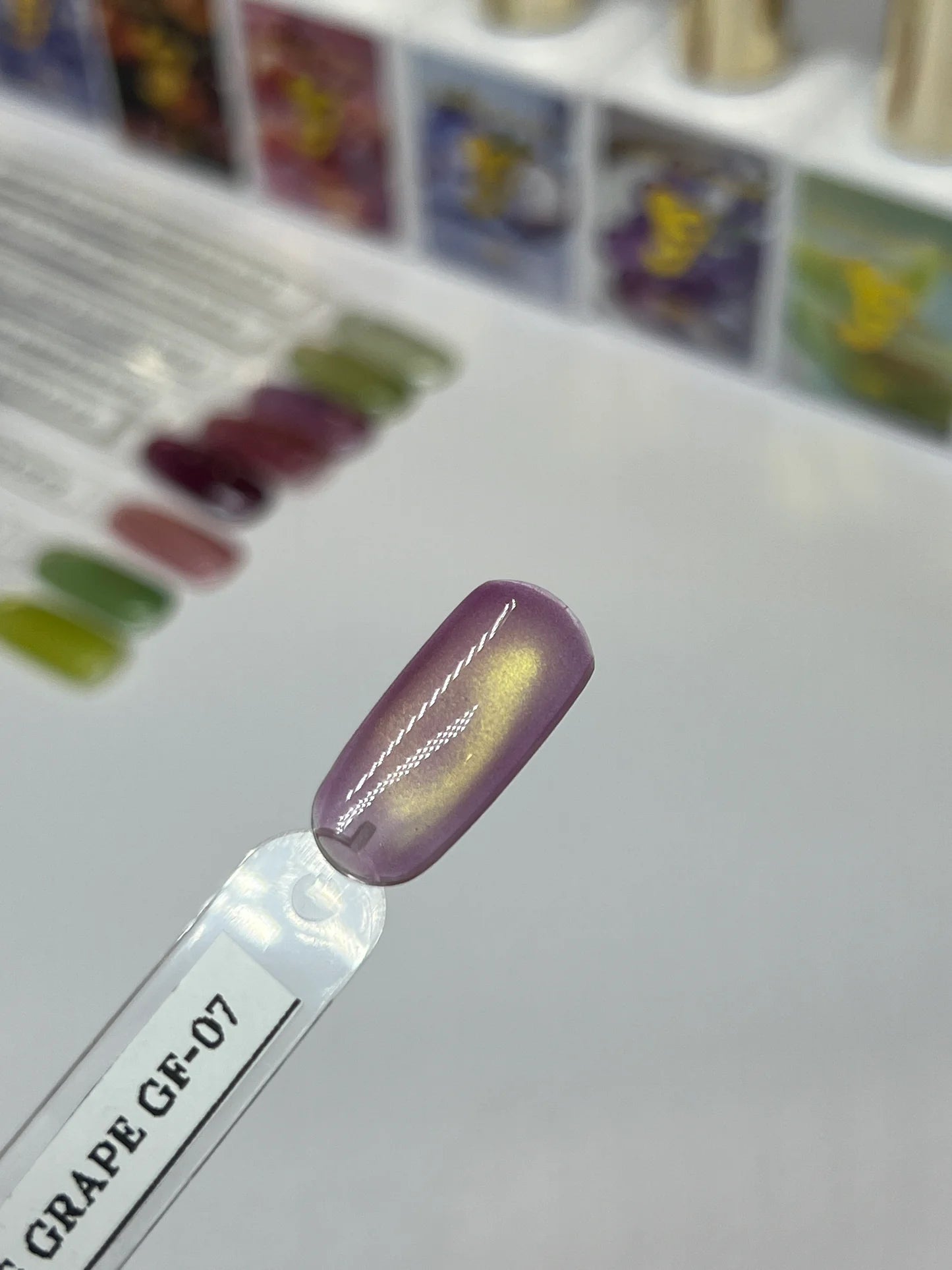 Sofi Art Gellicure Pro Cat Eye Gel Juicy Fruit Series Grape GF-07 applied on nails with a shiny, vibrant purple grape color.