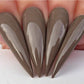 Kiara Sky Gel Polish in Country Chic shade, clear nail polish bottle with black cap, side view showing product label and color.