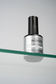 Luxio Prescription Soak Off Base™ gel for Luxio gel polish, shown in a clear bottle with applicator brush for super-bond adhesion.
