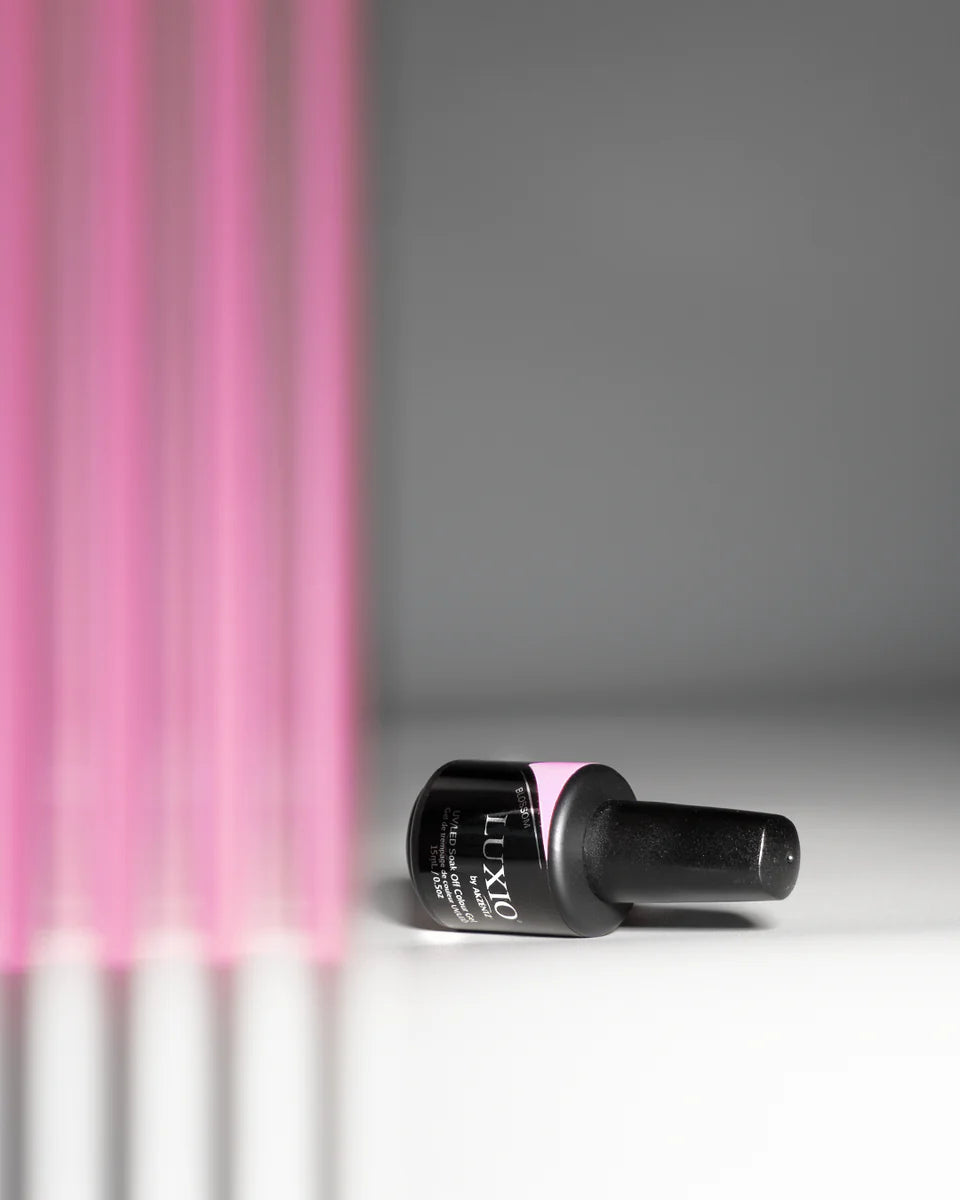 Luxio Gel Polish Blossom tint in 15ml bottle, showcasing the soft pink soak-off gel polish with floral-inspired color on the bottle