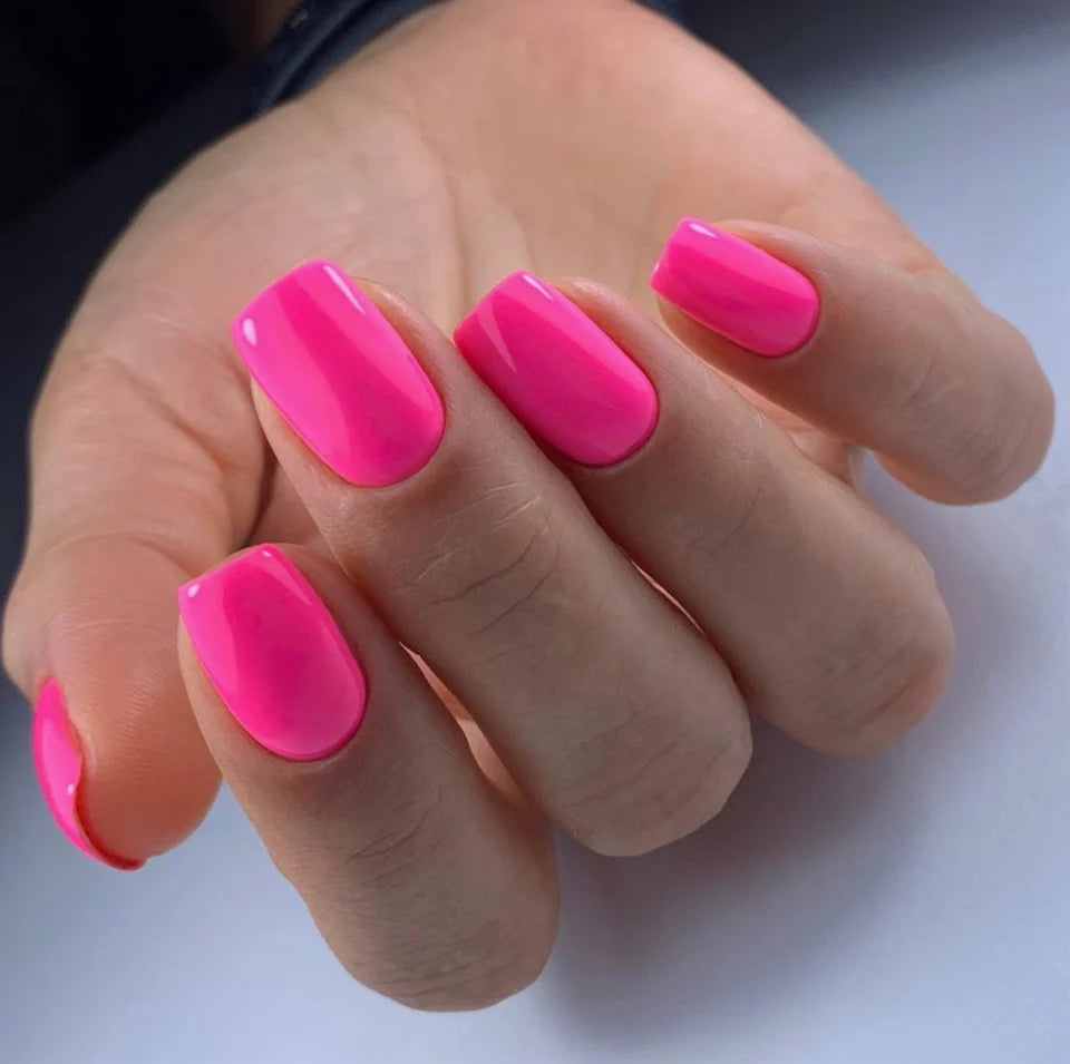 Luxio Soak-Off Gel Polish in Bombshell Bright 15ml bottle, showcasing vibrant coral color and glossy finish.
