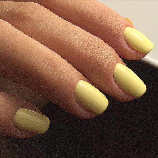 Luxio Cheerful Soak-Off Gel Polish in 15ml bottle, bright yellow color, with a smooth, glossy finish on a nail sample.