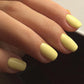 Luxio Cheerful Soak-Off Gel Polish in 15ml bottle, bright yellow color, with a smooth, glossy finish on a nail sample.
