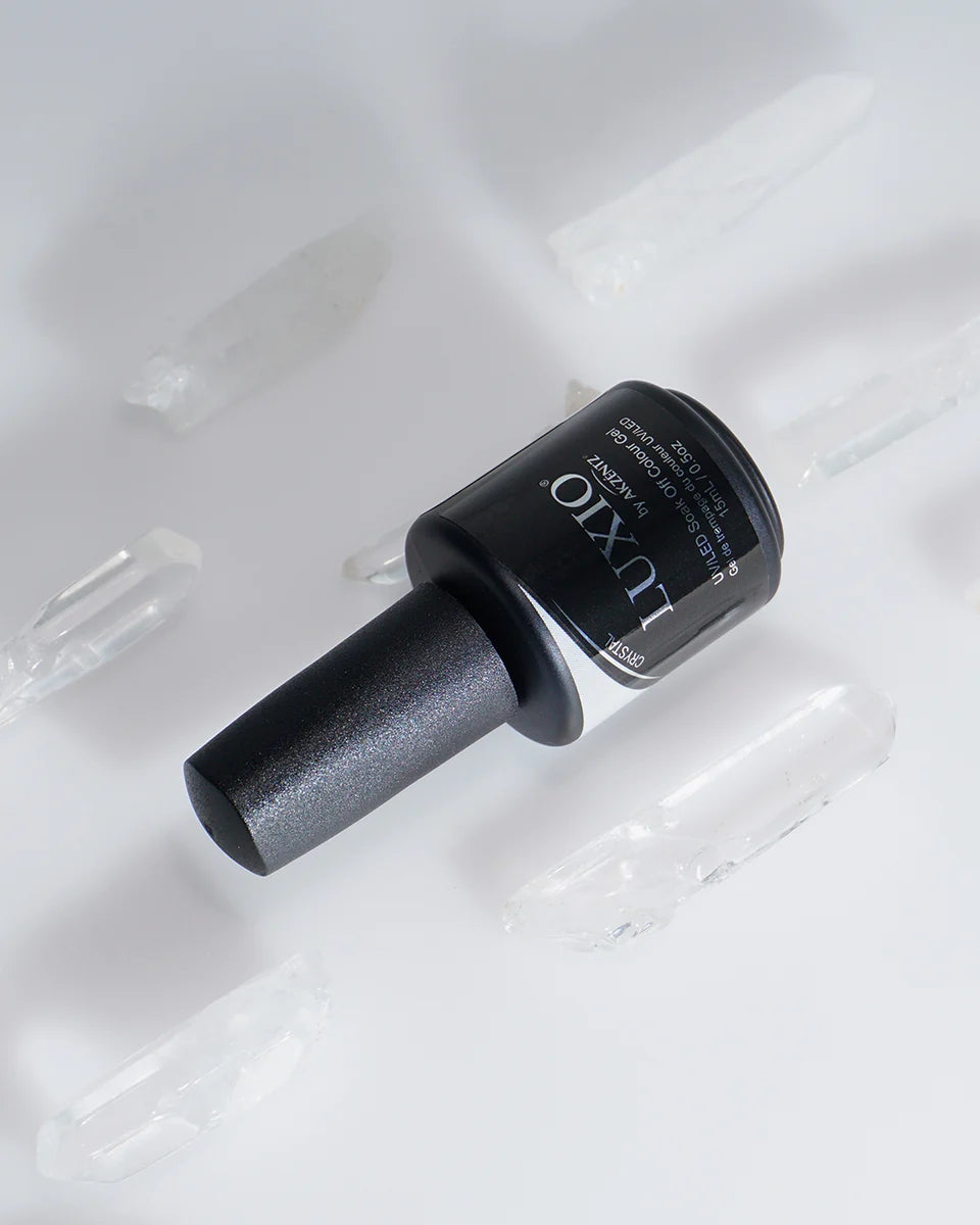 Luxio Crystal soak-off gel polish in 15ml bottle with sparkling crystal finish and black lid, designed for professional nail art.