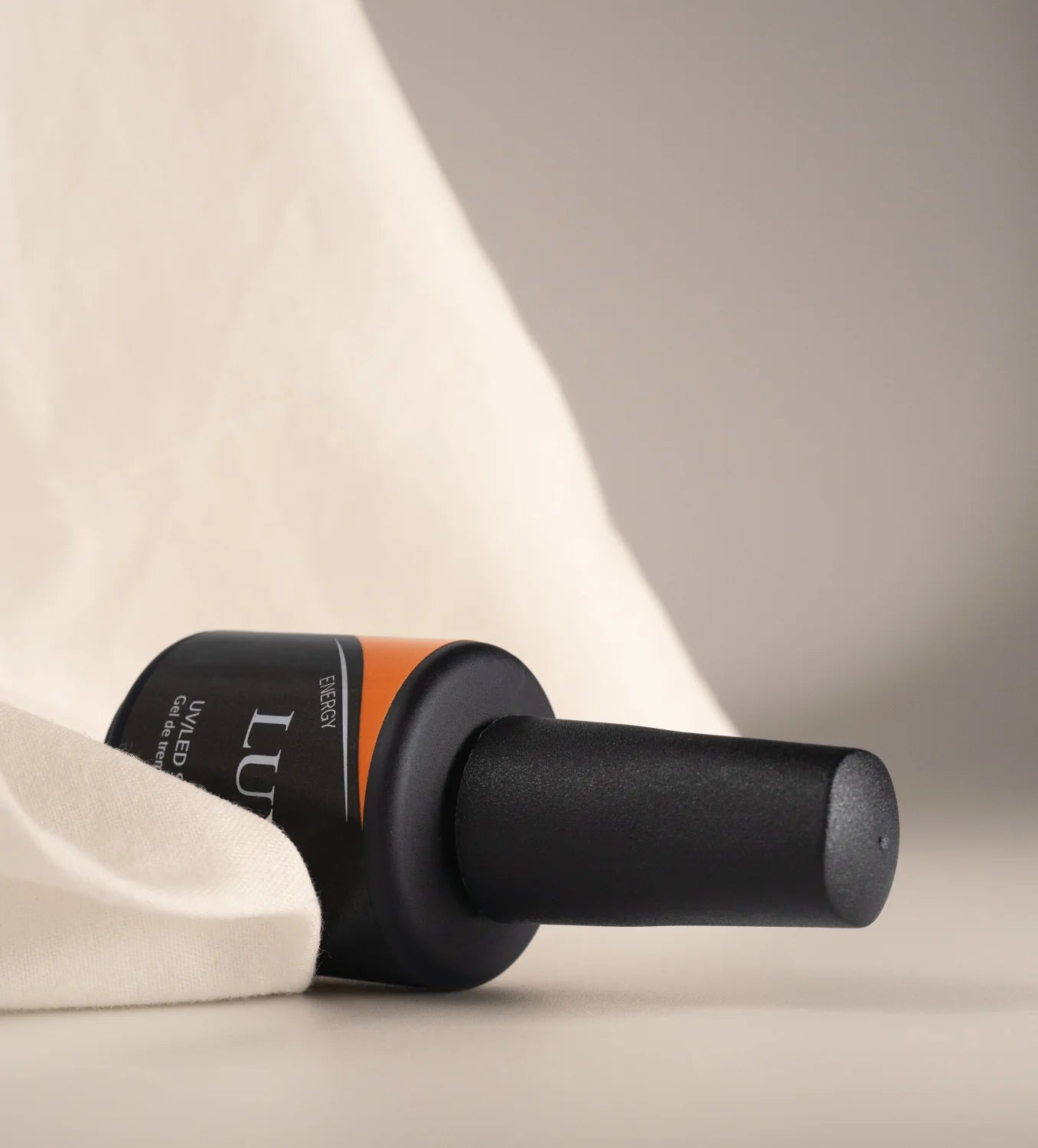 Closed bottle of Luxio Soak-Off Gel Polish Energy, 15ml, featuring a sleek design and vibrant label for professional nail care.