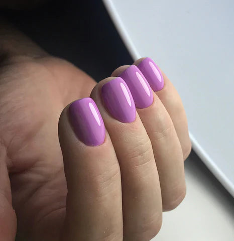 Luxio Soak-Off Gel Polish in Exposed 15ml bottle, showcasing a smooth, glossy pink nail color with a clear cap.