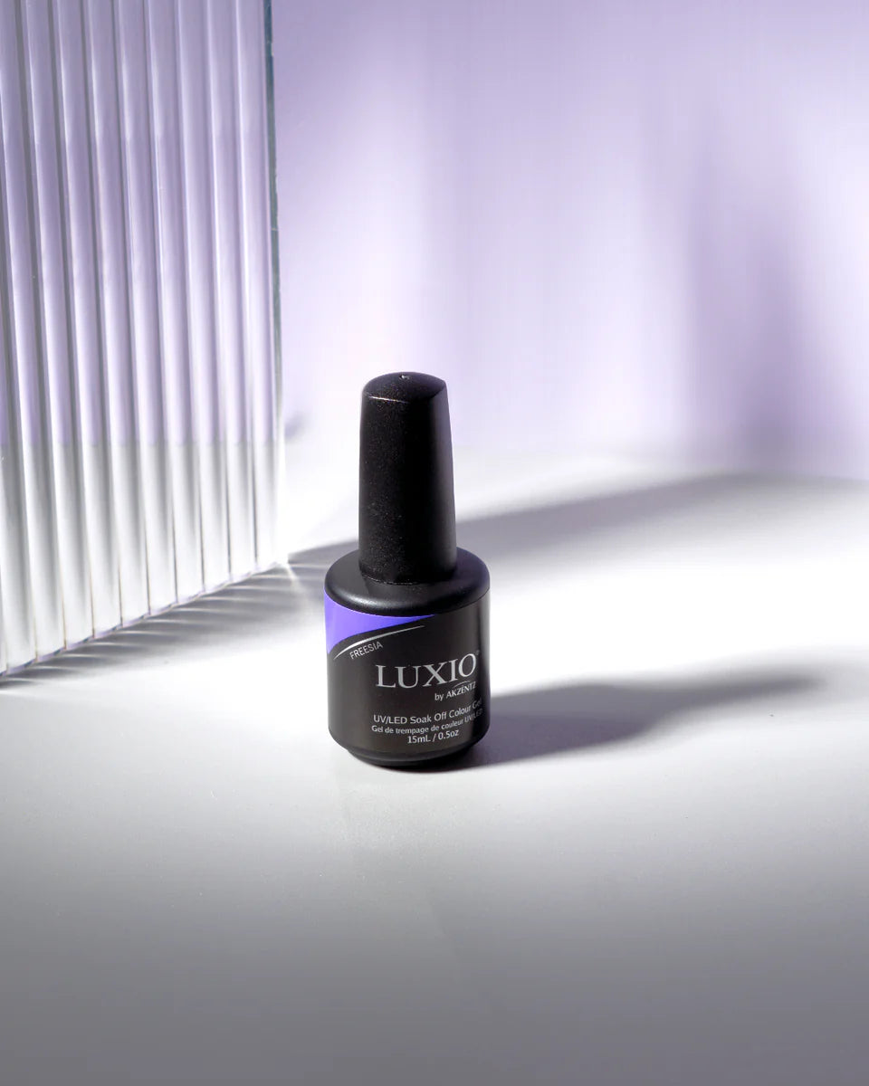Luxio Soak-Off Gel Polish in Freesia, 15ml bottle, with a vibrant pastel purple color and smooth glossy finish.