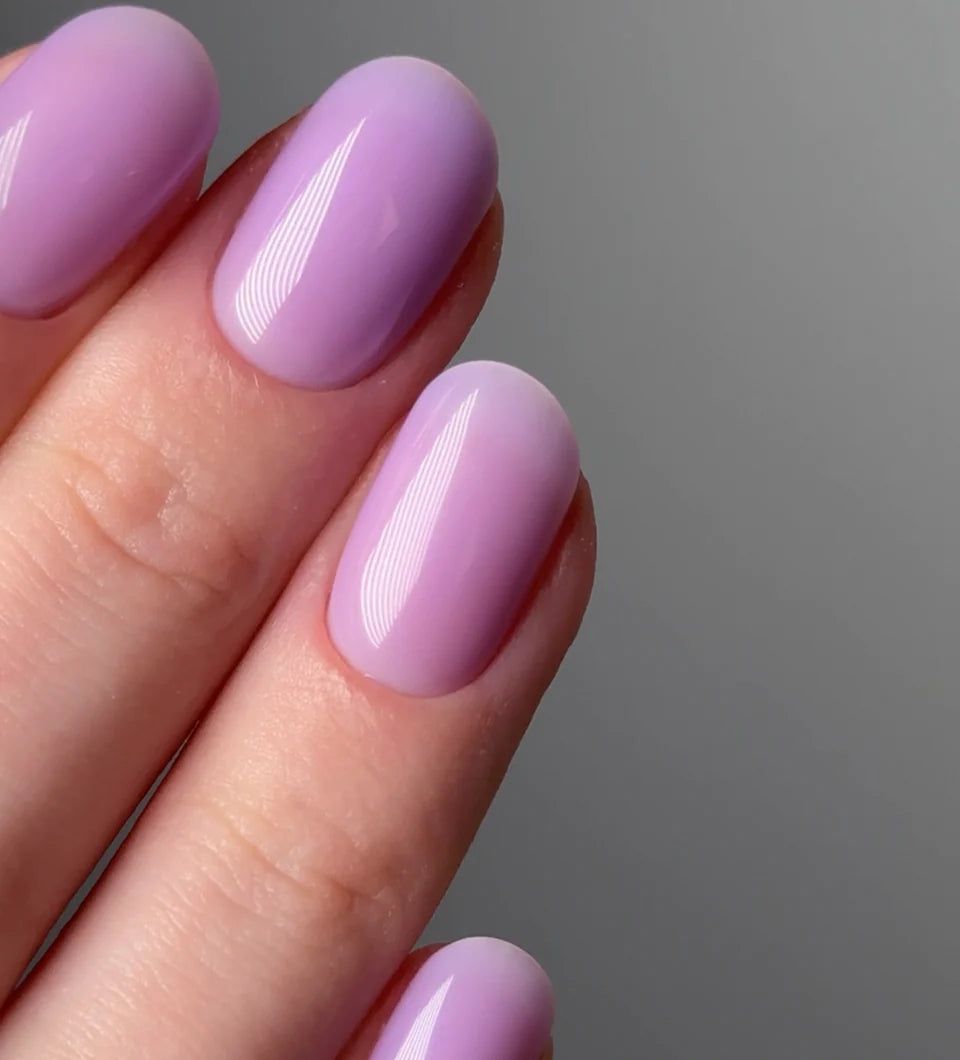 Luxio Soak-Off Gel Polish in Freesia tint, 15ml bottle, showing the vibrant purple gel polish color and branded packaging.