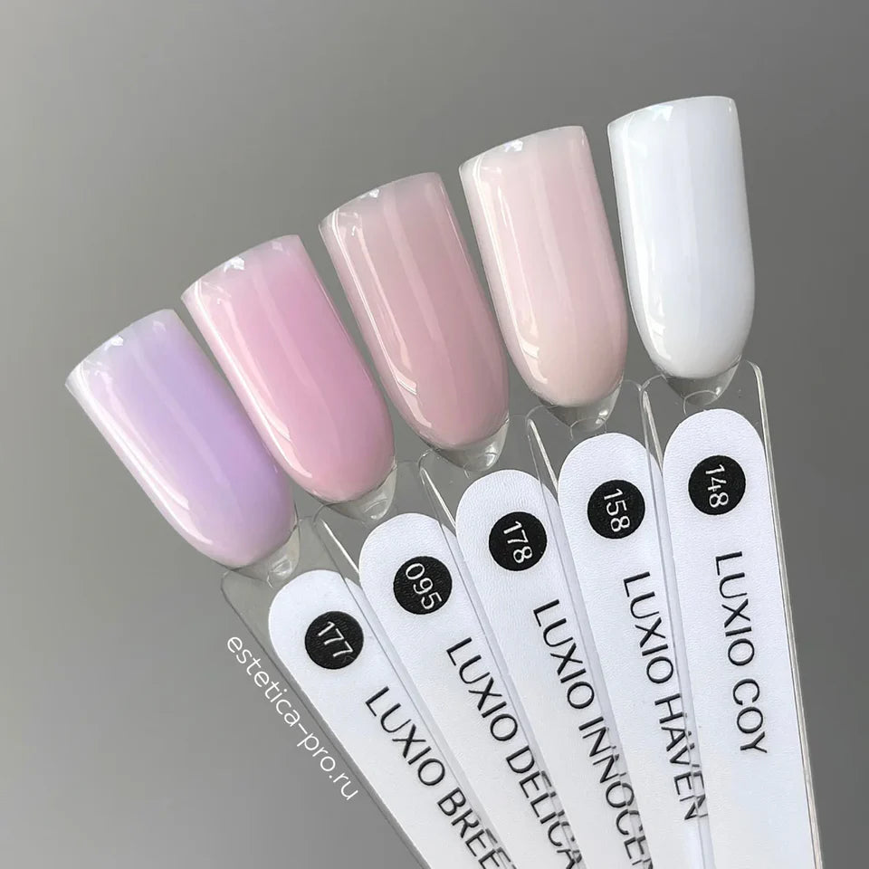Luxio Soak-Off Gel Polish Innocent sheer 15ml bottle, clear gel with a subtle pink tint, used for nail enhancement.
