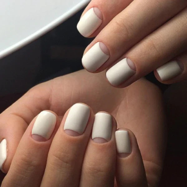 Luxio Soak-Off Gel Polish in Ivory, 15ml, with the gel bottle featuring a sleek design and label in a close-up shot.