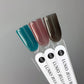 Luxio Soak-Off Gel Polish Jelli Teal 15ml bottle with colorful gel polish inside and applicator brush visible.