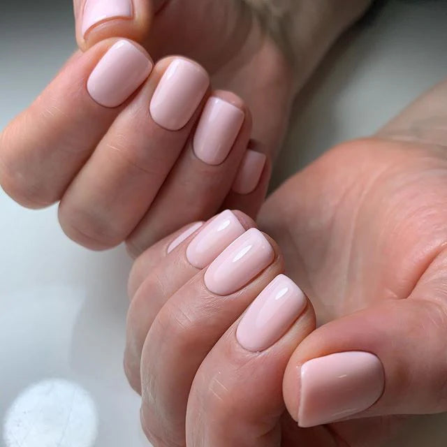 Luxio Soak-Off Gel Polish Lustful 15ml bottle with applicator brush, showcasing vibrant pink gel polish for nails.