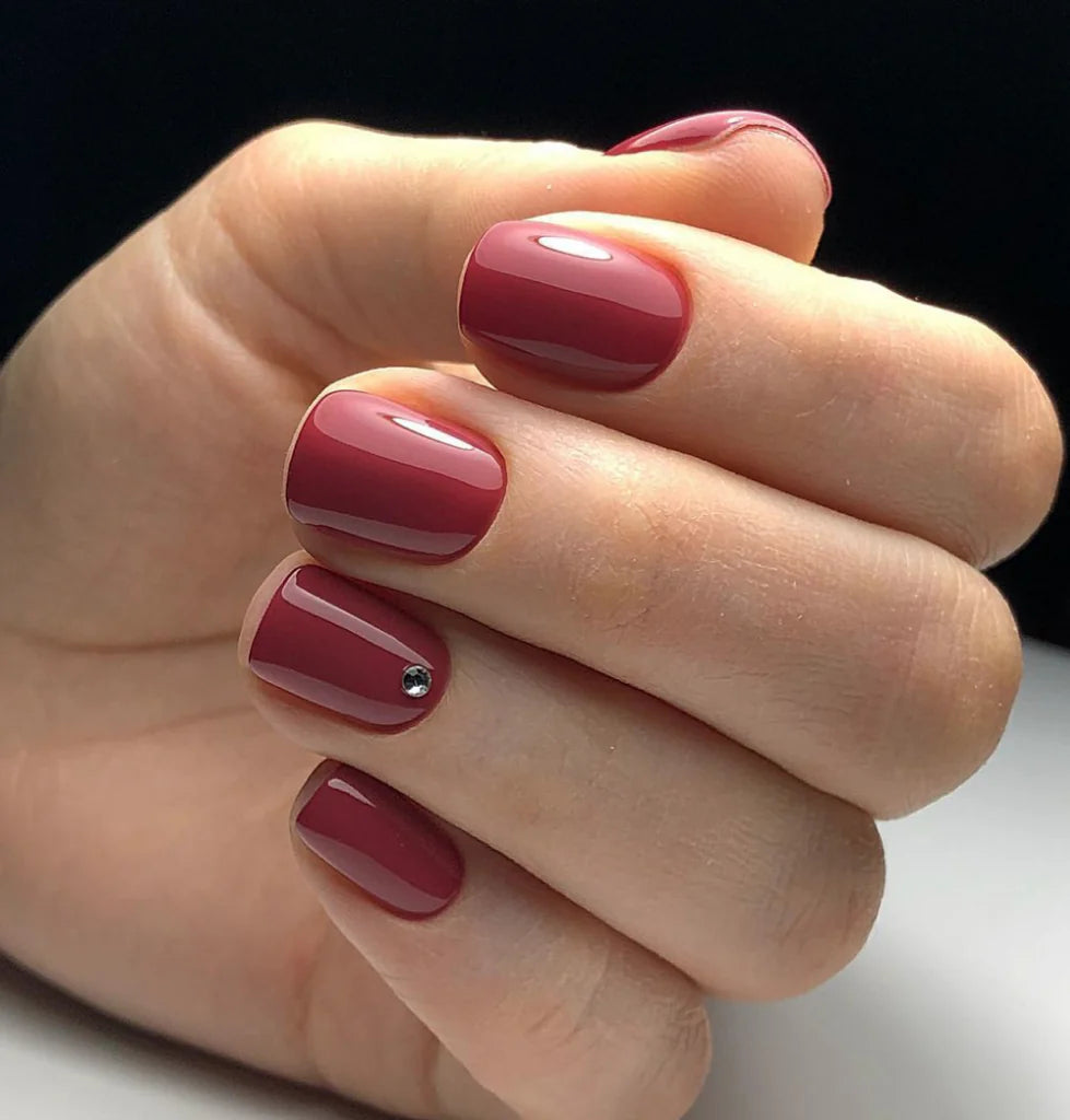 Luxio Soak-Off Gel Polish in Rebel shade, 15ml bottle, with vibrant dark red color and branded packaging.