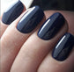 Luxio Soak-Off Gel Polish Spectra 15ml bottle with vibrant purple color and sleek packaging on a neutral background.