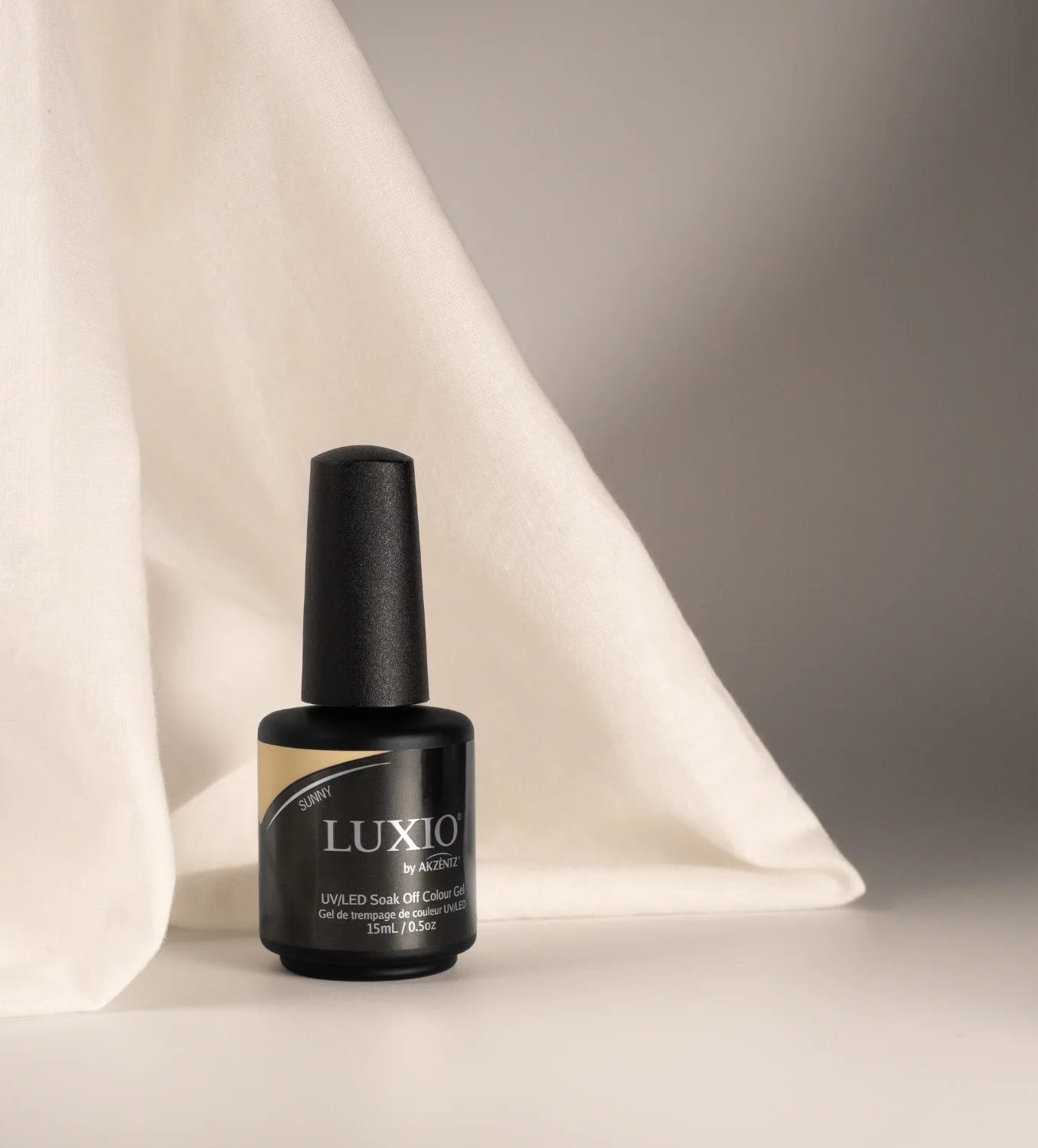 Luxio Soak-Off Gel Polish Sunny 15ml bottle showing the closed dark blue and yellow packaging for luxurious nail color.