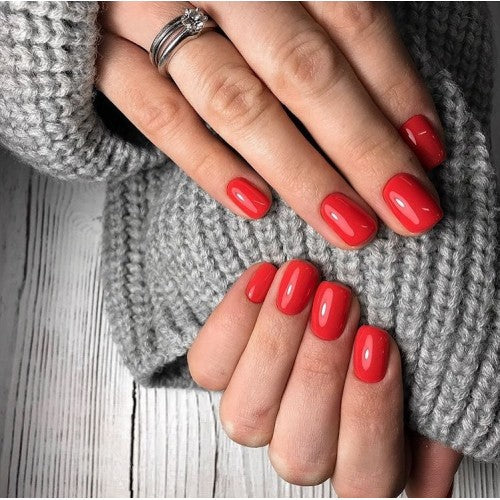 Luxio Soak-Off Gel Polish in Tango 15ml bottle, vibrant orange-red color with glossy finish, branded Luxio gel polish product.