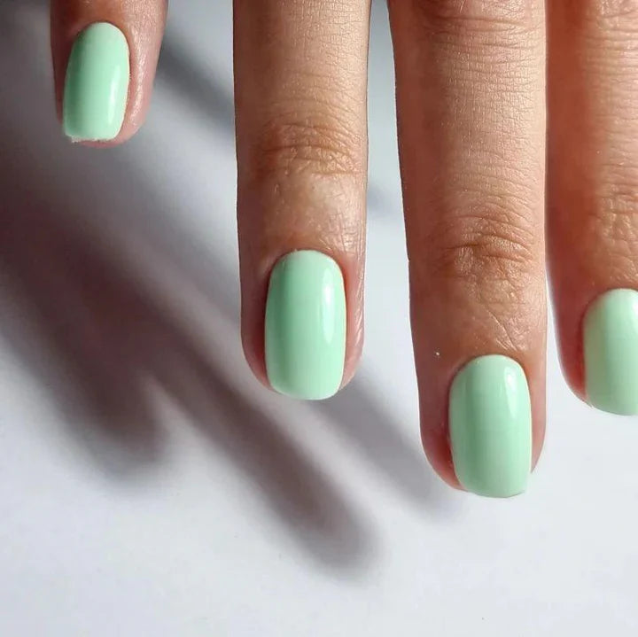 Luxio Luxio Soak-Off Gel Polish Wink 15ml bottle with pink gel polish for nails, displayed in a professional salon setting