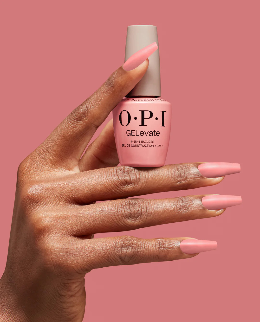 Opi GELevate Builder Gel Pink Over-Slay applied on nails, with a deep hand holding a 0.5oz bottle of gel.