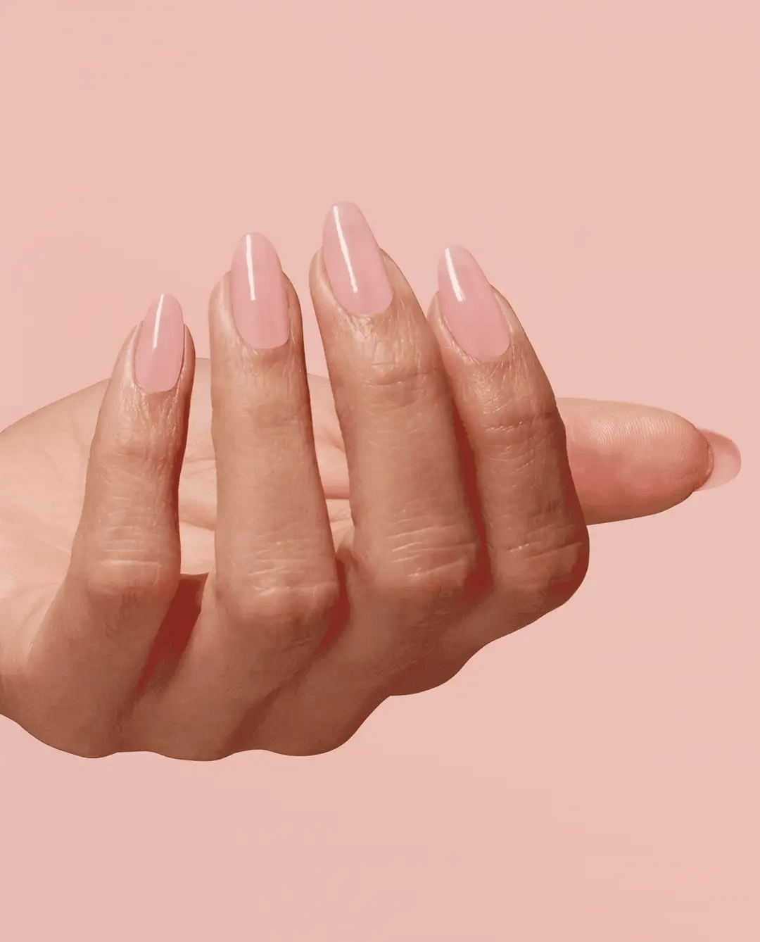 OPI Infinite Shine Passion nail polish bottle with vibrant pink color and glossy finish, displayed against a plain background.