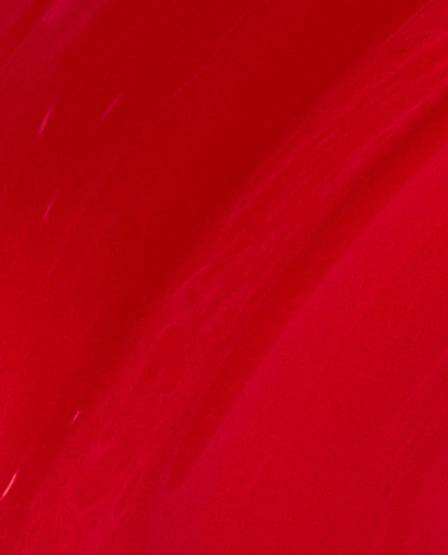 Swatch of OPI Intelli GelColor Big Apple Red gel nail polish on a brush, showcasing vibrant red color and smooth application.