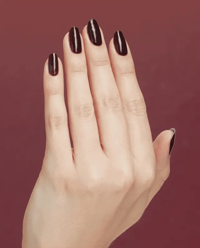 Opi Intelli GelColor gel nail polish in Complimentary Wine on a hand with painted nails.