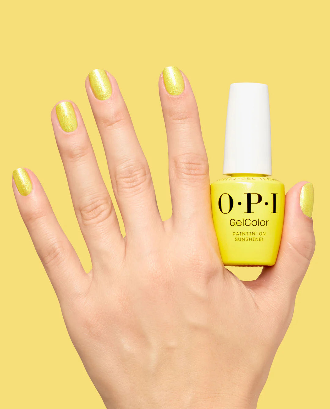 OPI Pro Health GelColor and matching lacquer Paintin' on Sunshine! gel nail polish and lacquer on a hand with the product bottles