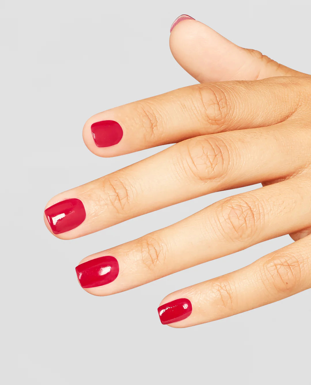 Opi Intelli GelColor Red gel nail polish bottle with a red nail manicure on natural nails, showcasing the vibrant color.