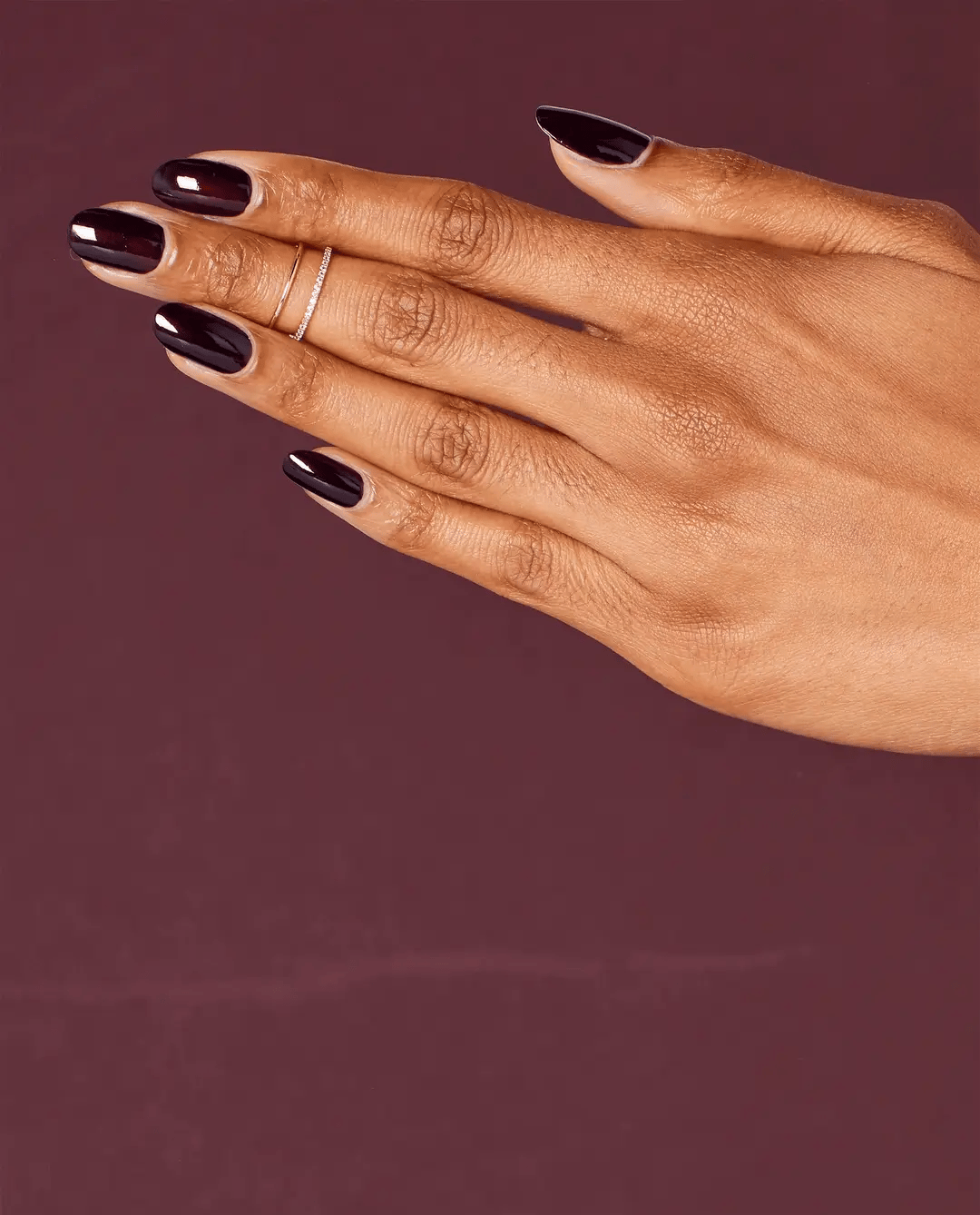 OPI Nail Polish in Black Cherry Chutney shade, showcasing a glossy, deep cherry red color on the nail.