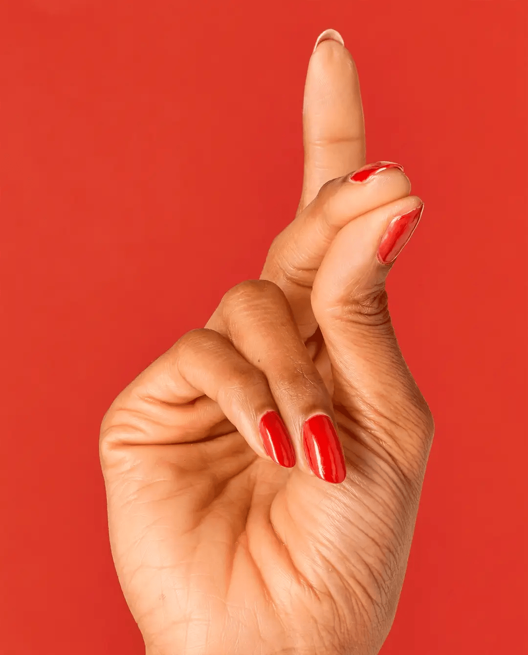 OPI Nail Polish in Gimme A Lido Kiss shade, vibrant coral-pink color, smooth liquid nail polish bottle with label visible