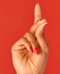 OPI Nail Polish in Gimme A Lido Kiss shade, vibrant coral-pink color, smooth liquid nail polish bottle with label visible