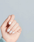 OPI Kyoto Pearl NLL03 nail polish bottle with the pearl-toned polish visible in the open bottle, showcasing the product's elegant color.