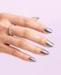 Hand with OPI Leonardo's Model Color MI011 nail polish, showcasing a vibrant nail color on neatly groomed nails.