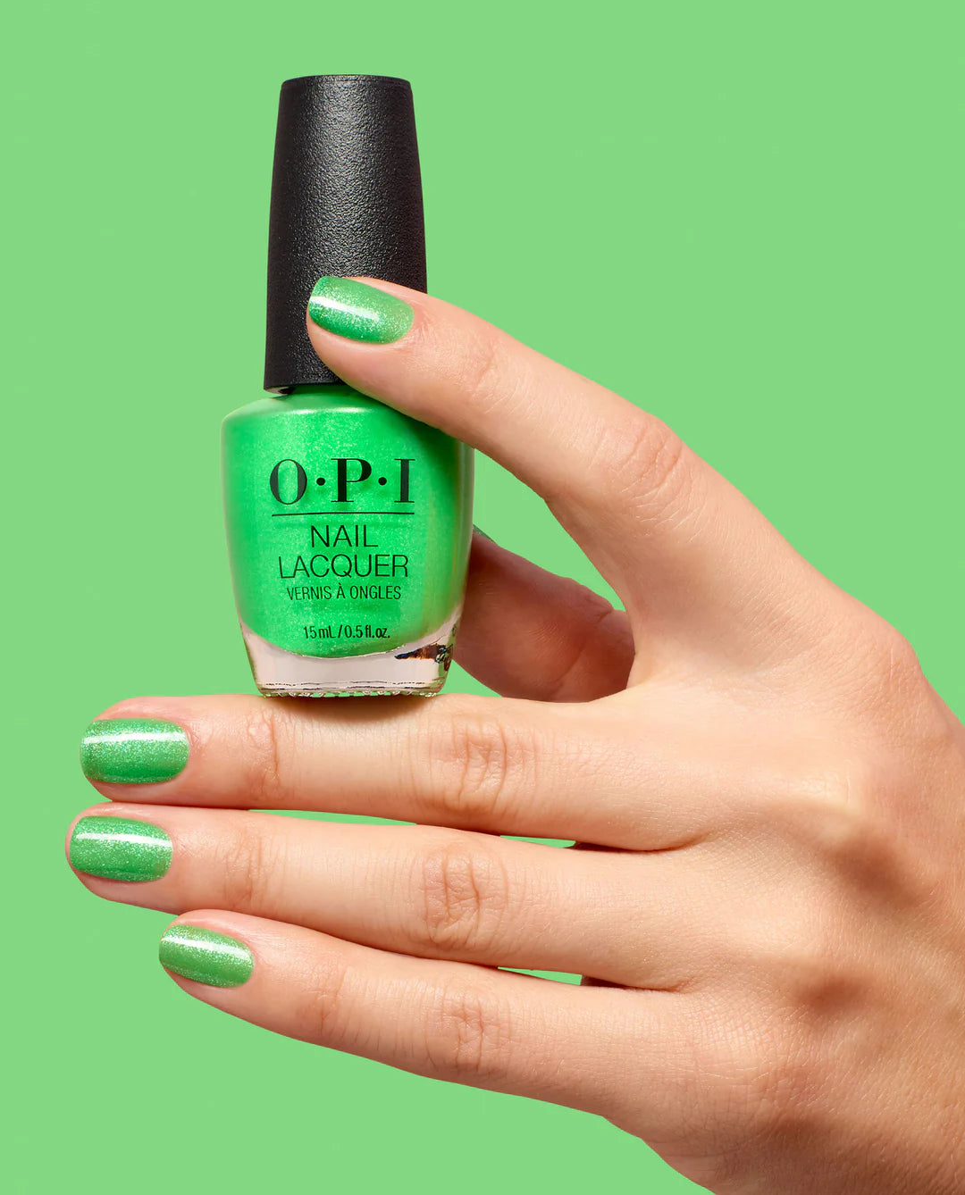 Bright lime green OPI nail polish bottle and hand showcasing the vibrant Lime Of My Life NLS078 nail lacquer.